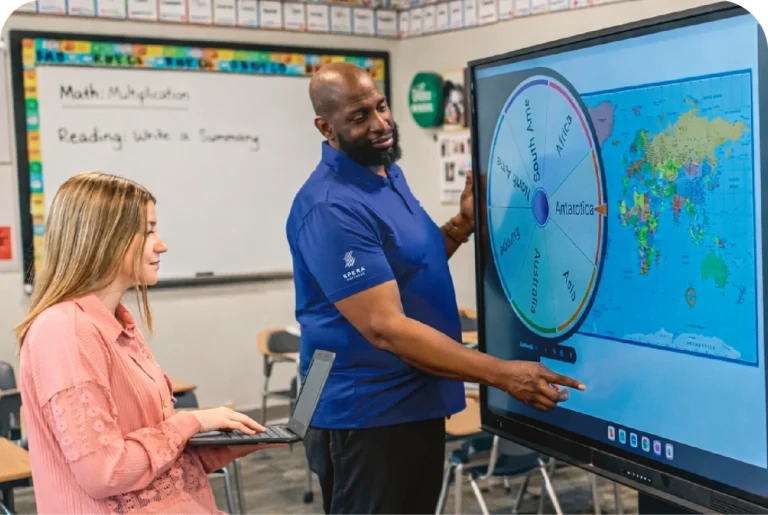 Spera Partners IT support technician assisting K-12 educator with interactive display in Pittsburgh classroom