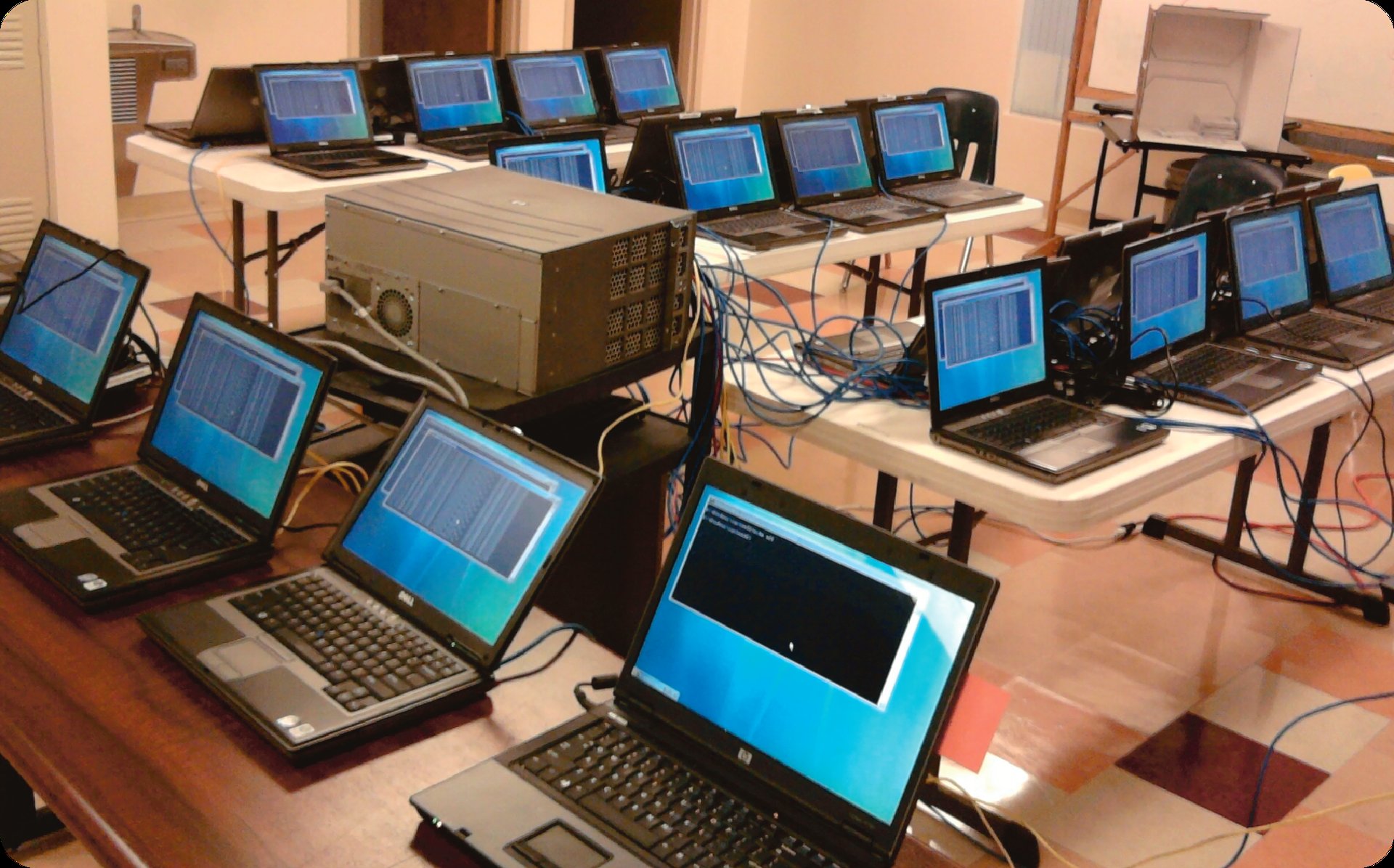 Rows of hundreds of laptops being imaged and configured for bulk procurement and large scale deployment in Pittsburgh.