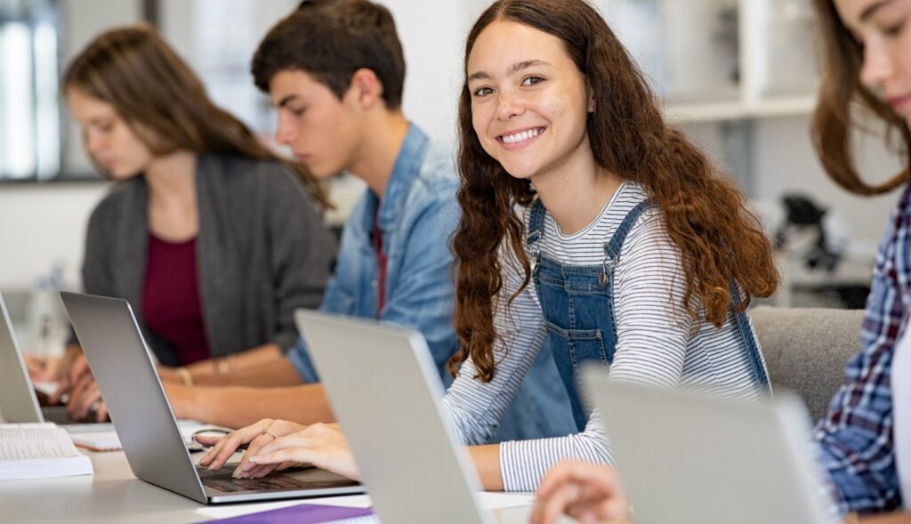 Students working on laptops in a classroom