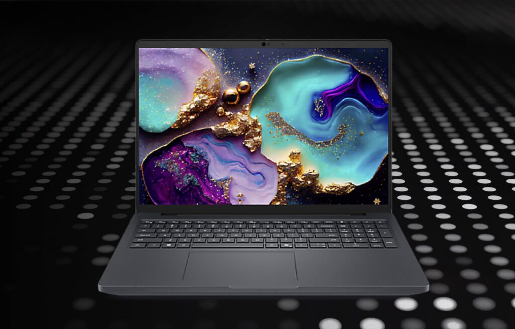 Laptop computer with colorful marbling on the screen, sitting on techy black & white polka dot surface.